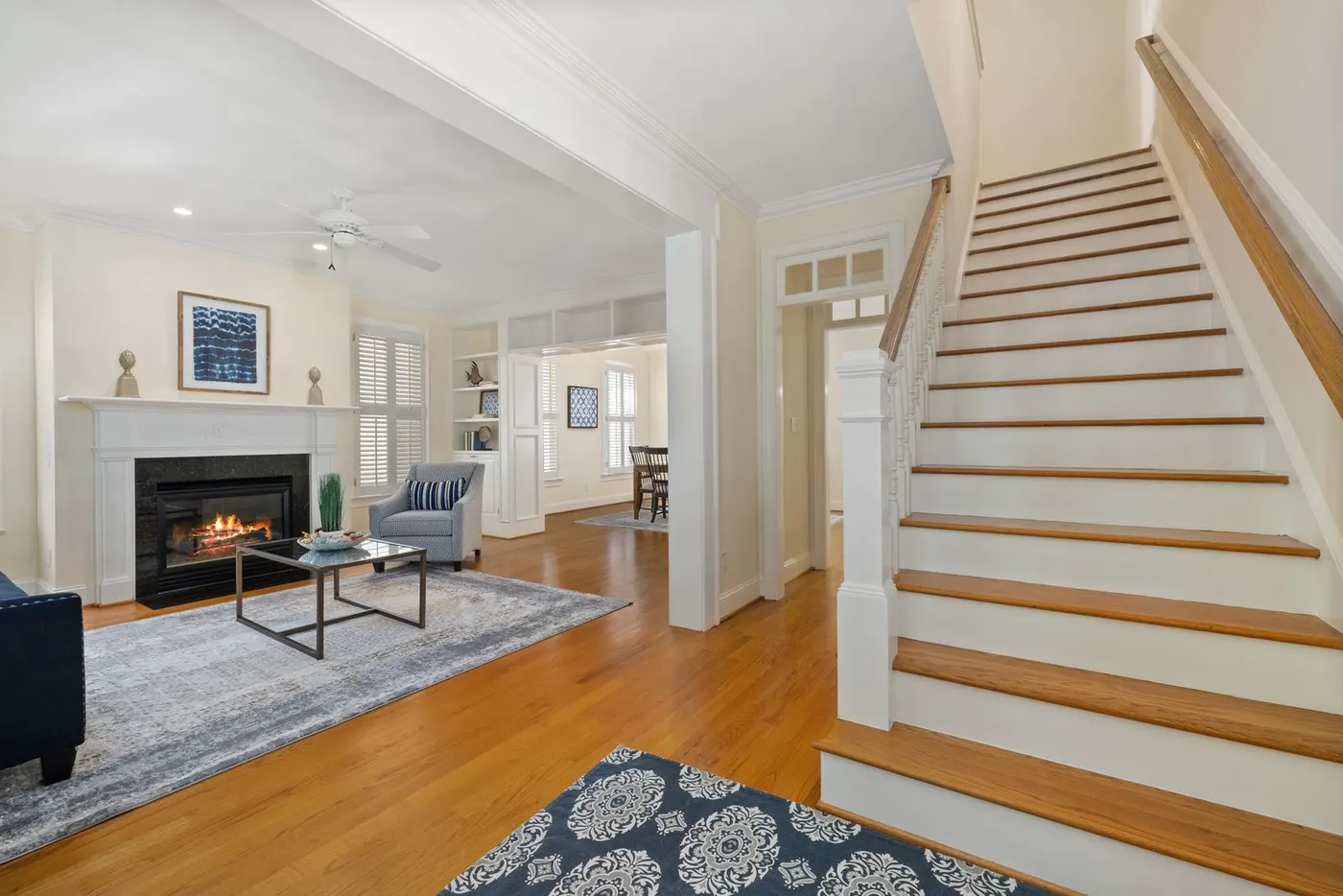 Bright staged living room with fireplace and hardwood floors