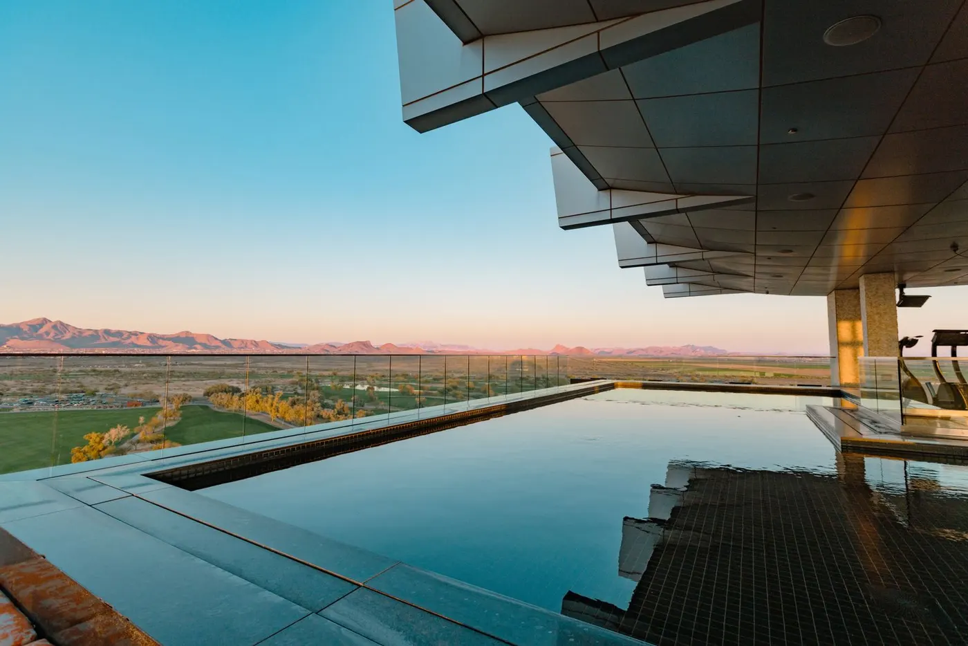 Infinity pool overlooking the desert at sunset